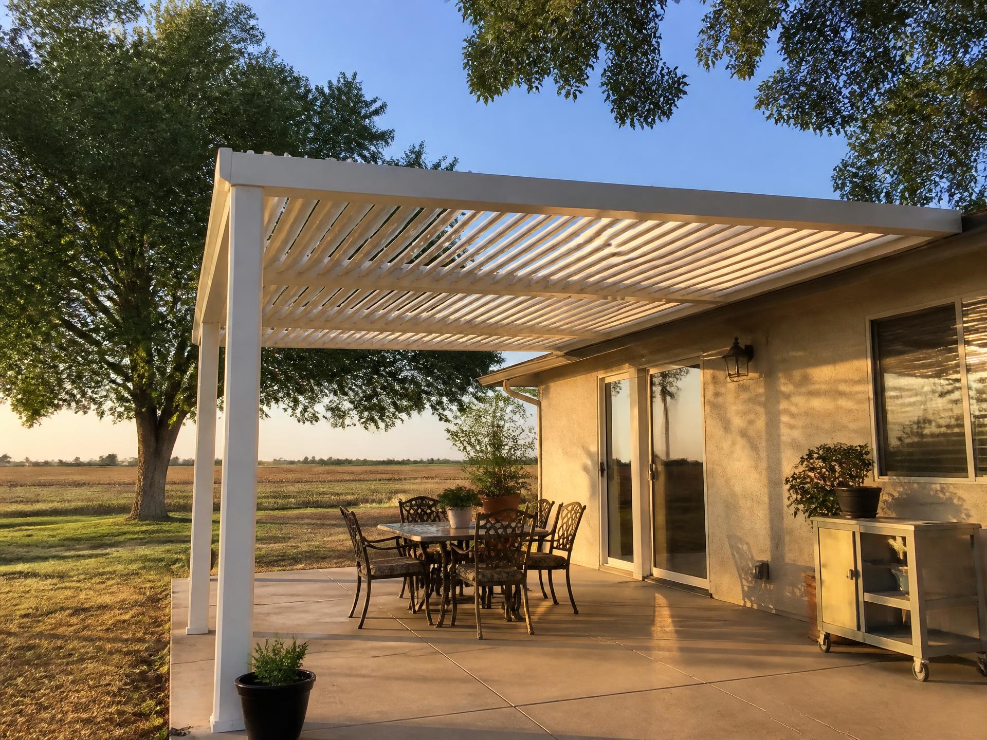 Custom louvered aluminum patio cover installed on a home in Fowler, CA