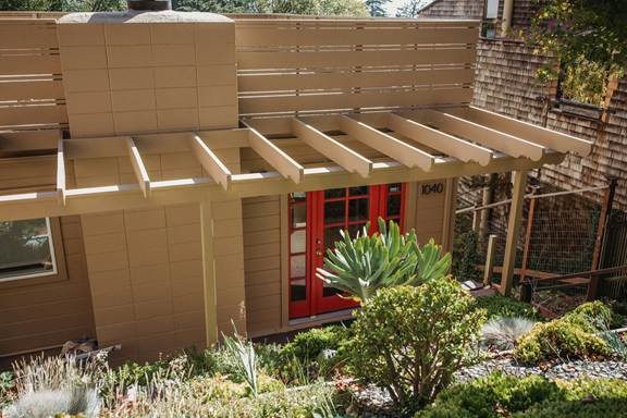 Custom patio covers in Sanger designed to complement a landscaped residential patio