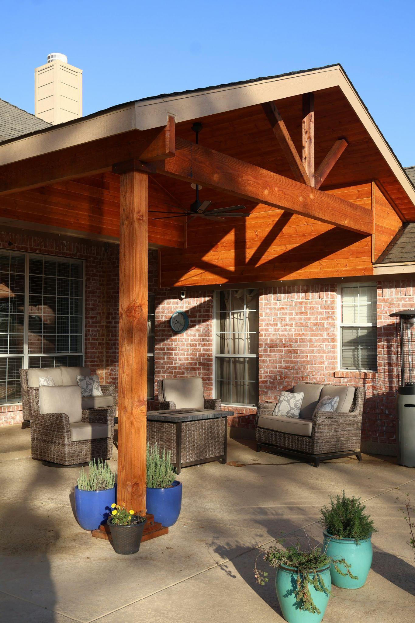 A wooden covered patio creates a comfortable outdoor seating area, illustrating options for adjustable patio covers in Tollhouse.