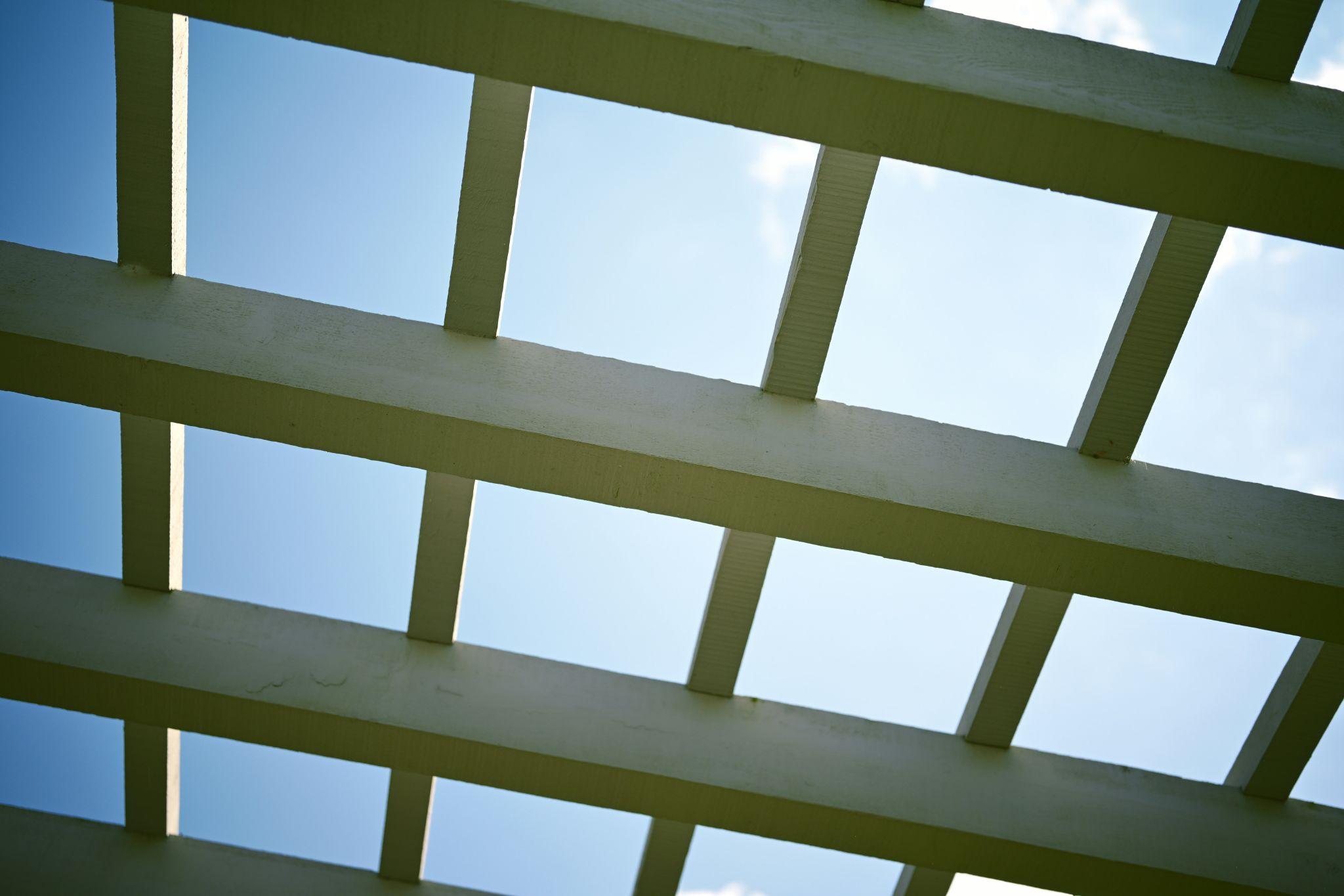 A pergola-style structure provides shade and enhances outdoor spaces with stylish patio covers in Tollhouse.