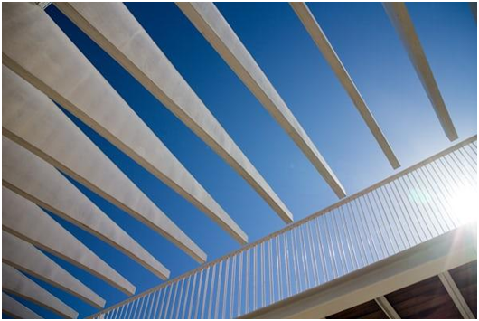 Contractors completing patio cover installation in Clovis