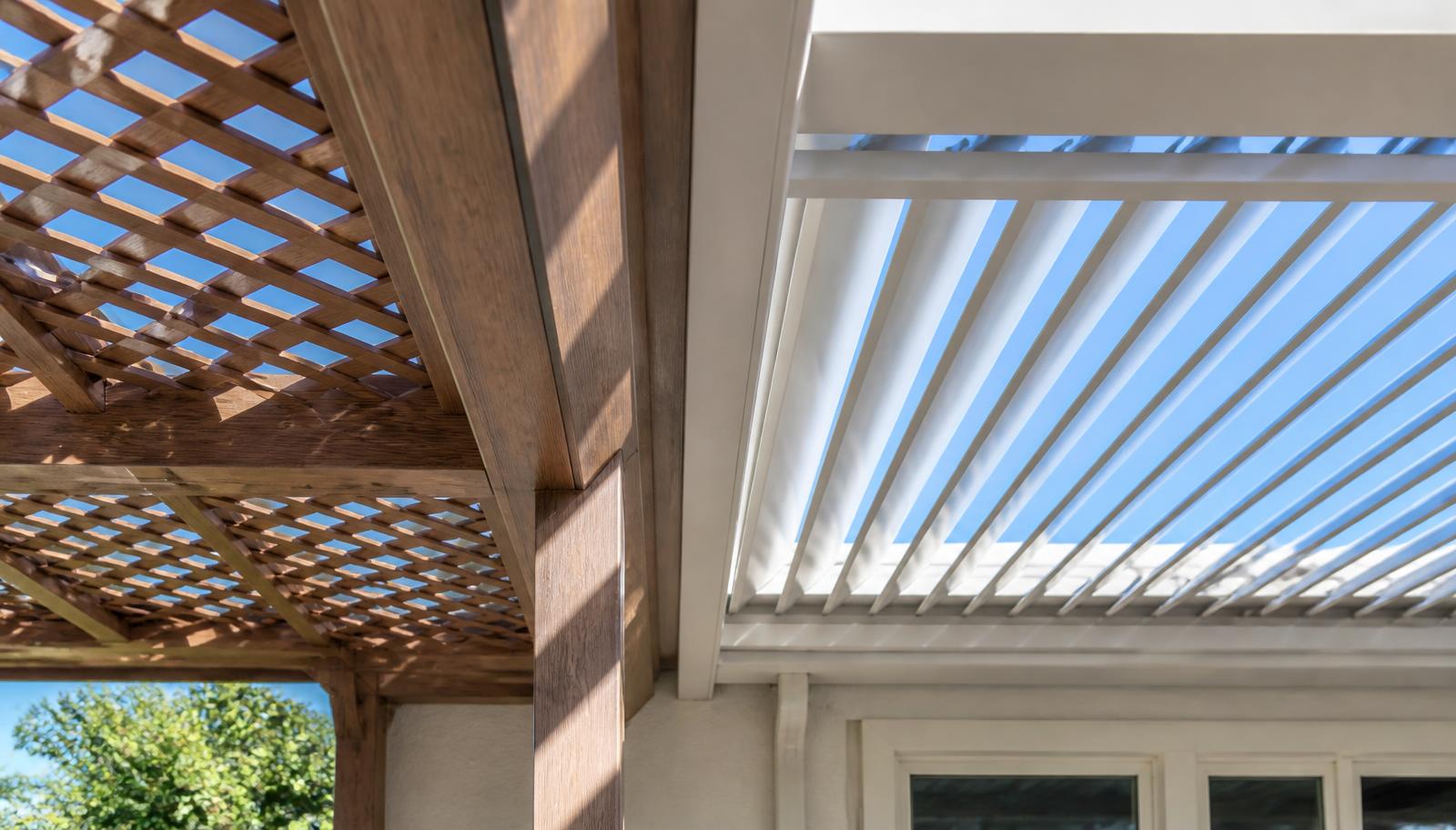 Wood-look fixed aluminum lattice cover beside an adjustable aluminum louvered roof for comparison.